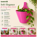 Pink wall hanging planter with green plants on a beige wall, featuring GardenTrails branding and product features.